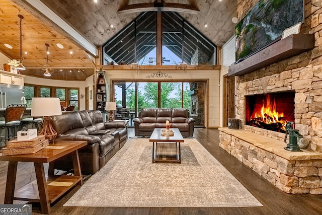 living room featuring dark wood-type flooring, beam ceiling, high vaulted ceiling, wooden ceiling, and a fireplace