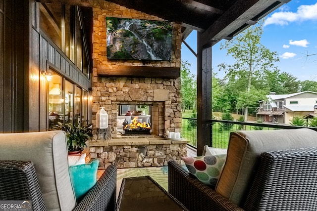 balcony featuring an outdoor stone fireplace