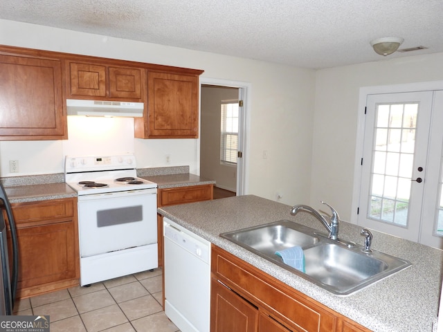 kitchen with sink, white appliances, a textured ceiling, light tile patterned flooring, and french doors