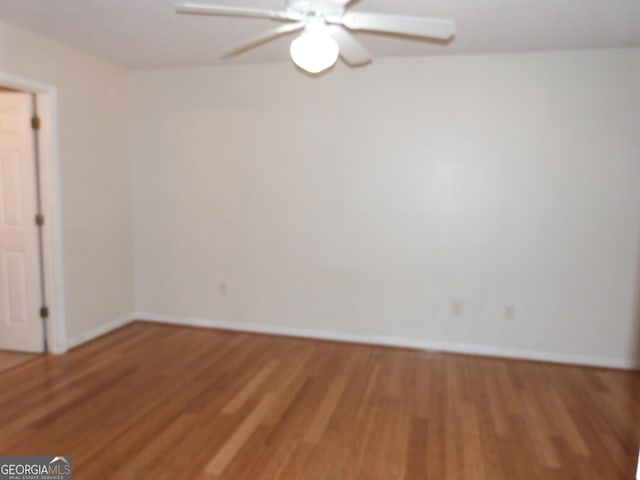 unfurnished room with hardwood / wood-style flooring and ceiling fan