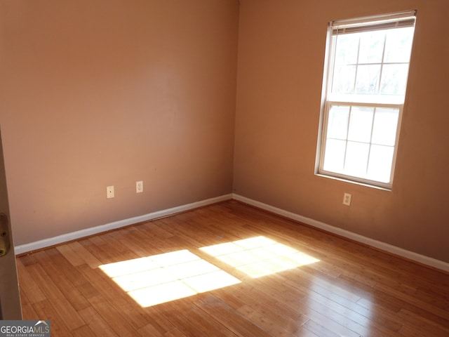 spare room featuring light hardwood / wood-style flooring