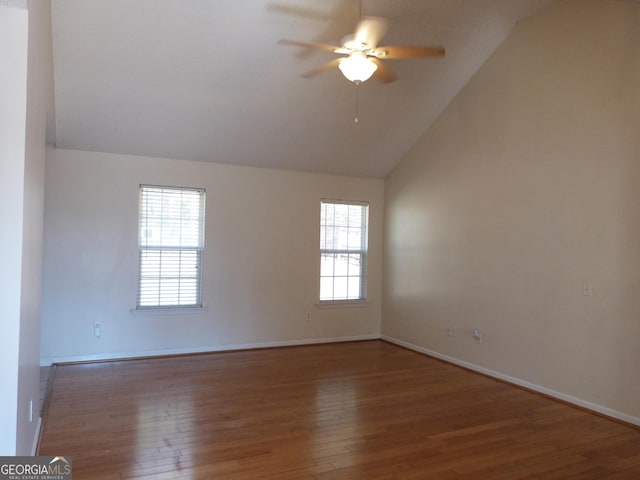 spare room with hardwood / wood-style floors, vaulted ceiling, and a healthy amount of sunlight