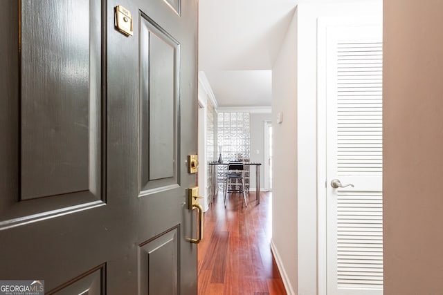 hall featuring dark hardwood / wood-style flooring and ornamental molding