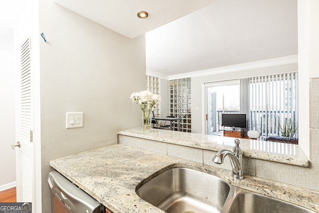 kitchen featuring sink, light stone counters, stainless steel dishwasher, wood-type flooring, and ornamental molding