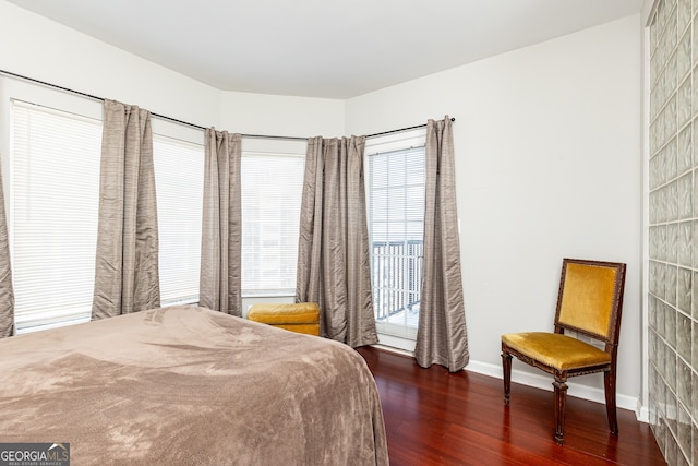 bedroom with dark hardwood / wood-style floors