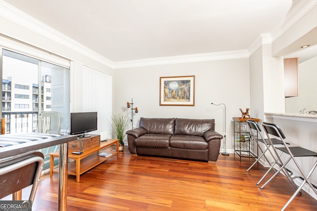 living room featuring hardwood / wood-style flooring and ornamental molding