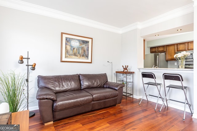 living room with crown molding and dark wood-type flooring