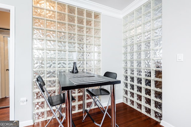 dining space with hardwood / wood-style floors and ornamental molding