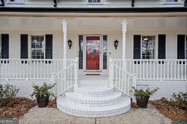 view of exterior entry with a porch