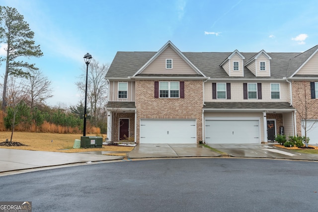 view of front of house with central AC unit and a garage