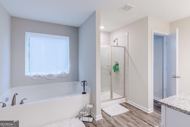 bathroom featuring separate shower and tub, vanity, and hardwood / wood-style flooring