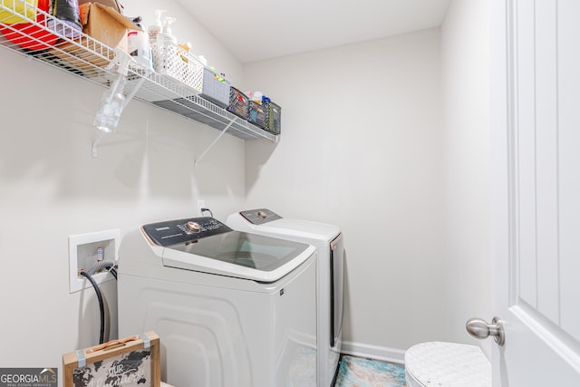 clothes washing area with washing machine and dryer