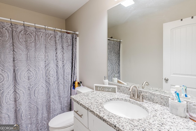 bathroom with vanity and toilet