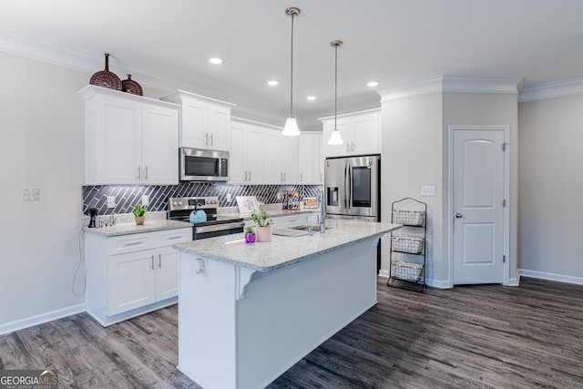 kitchen featuring a kitchen island with sink, white cabinets, and stainless steel appliances