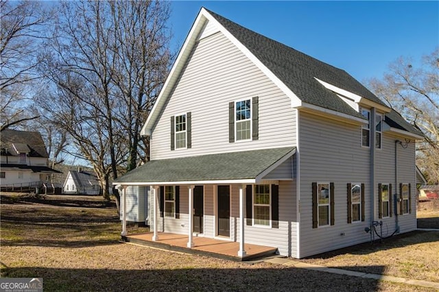 back of property featuring covered porch