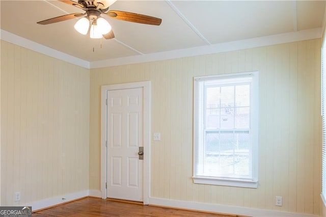 unfurnished room featuring ceiling fan, ornamental molding, and hardwood / wood-style floors