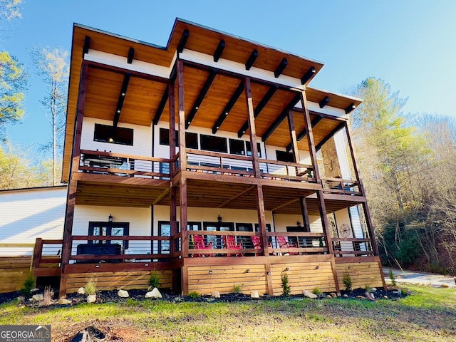 rear view of house featuring a wooden deck