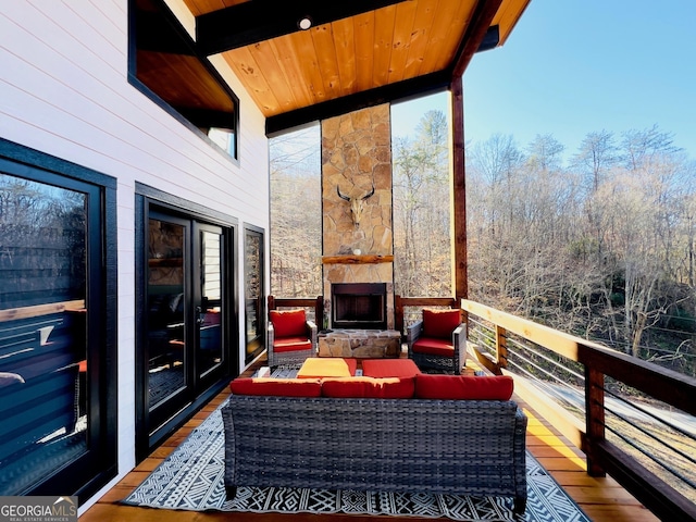 wooden deck featuring an outdoor living space with a fireplace