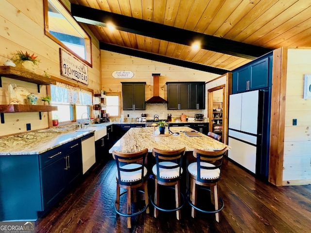 kitchen with custom range hood, white refrigerator, lofted ceiling with beams, dark hardwood / wood-style floors, and a kitchen island