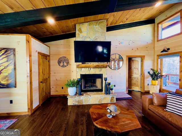 living room featuring vaulted ceiling with beams, wood walls, a stone fireplace, and dark wood-type flooring