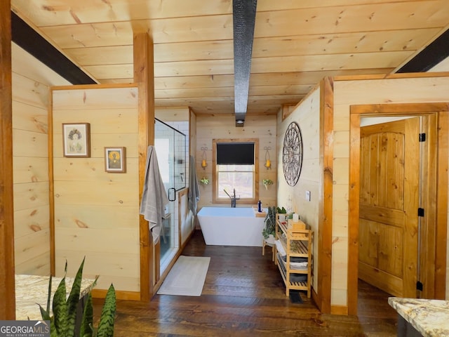 hallway featuring beamed ceiling, dark hardwood / wood-style flooring, wooden ceiling, and wooden walls