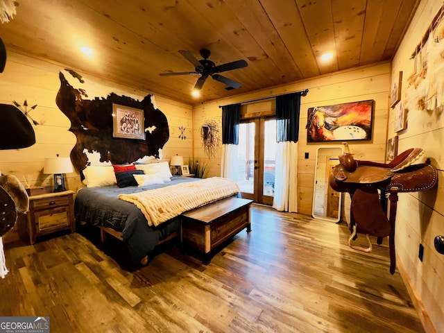 bedroom with hardwood / wood-style floors, access to outside, ceiling fan, and wooden ceiling