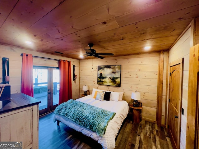 bedroom with access to exterior, ceiling fan, wooden ceiling, dark hardwood / wood-style floors, and wood walls