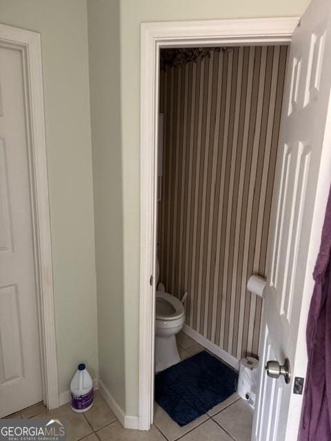 bathroom with tile patterned flooring and toilet