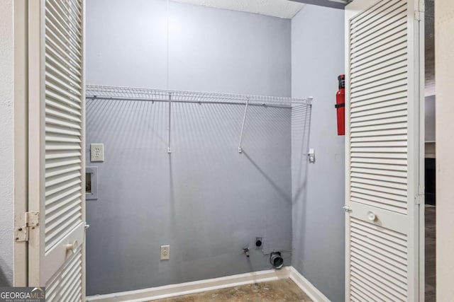 laundry area featuring hookup for a washing machine and a textured ceiling