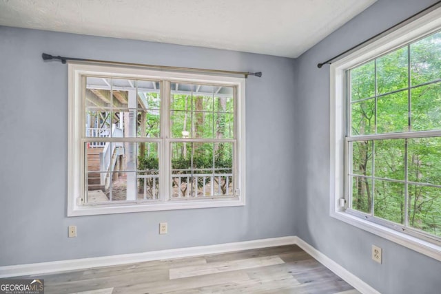 unfurnished room with light hardwood / wood-style flooring