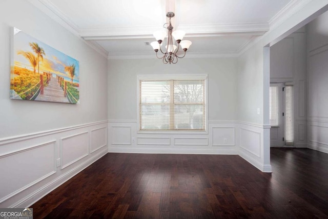 spare room featuring crown molding, dark hardwood / wood-style floors, and an inviting chandelier