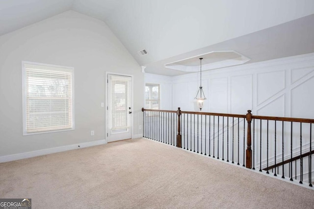 interior space featuring a chandelier, a healthy amount of sunlight, and vaulted ceiling