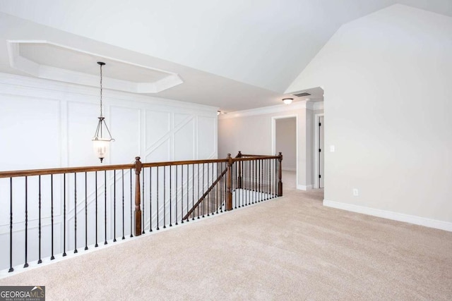 spare room with ornamental molding, light carpet, and vaulted ceiling