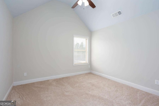 empty room with light carpet, ceiling fan, and lofted ceiling