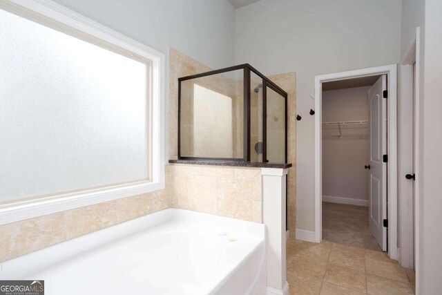 bathroom featuring tile patterned floors and independent shower and bath