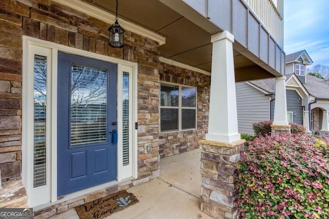 view of exterior entry with covered porch