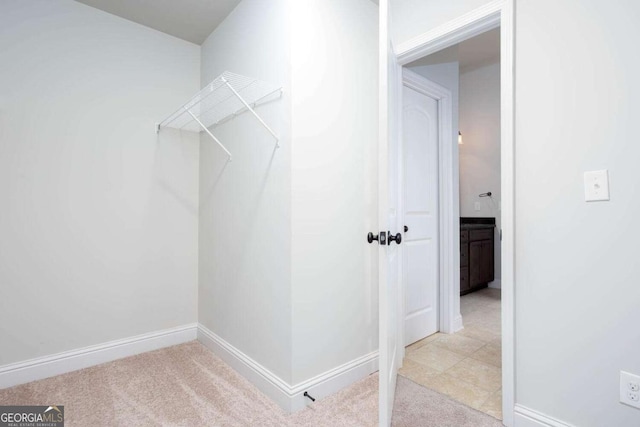 spacious closet with light colored carpet