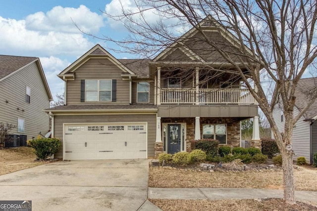 view of front of house with central AC, a balcony, and a garage