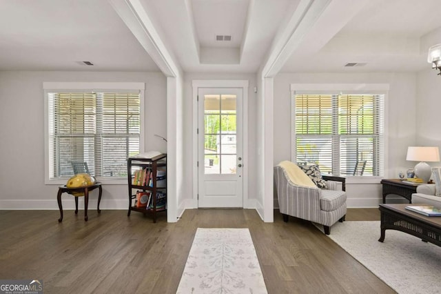 living room with dark hardwood / wood-style flooring and a tile fireplace