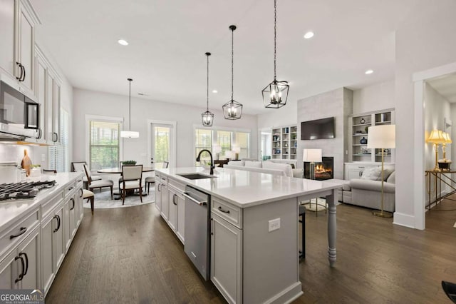 dining space featuring a wealth of natural light, sink, and dark wood-type flooring