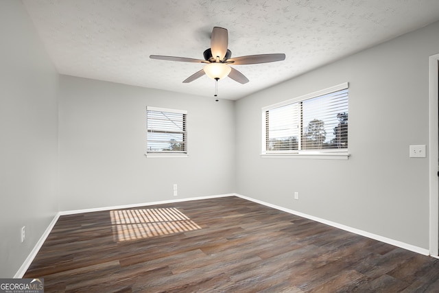 unfurnished room featuring ceiling fan, dark hardwood / wood-style flooring, and a textured ceiling