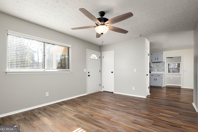 entryway featuring a textured ceiling, ceiling fan, and dark hardwood / wood-style floors