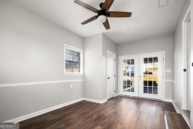 empty room with french doors, dark hardwood / wood-style floors, and ceiling fan