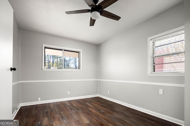 unfurnished room featuring ceiling fan and dark wood-type flooring