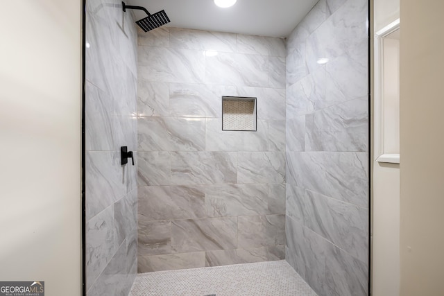 bathroom with a tile shower