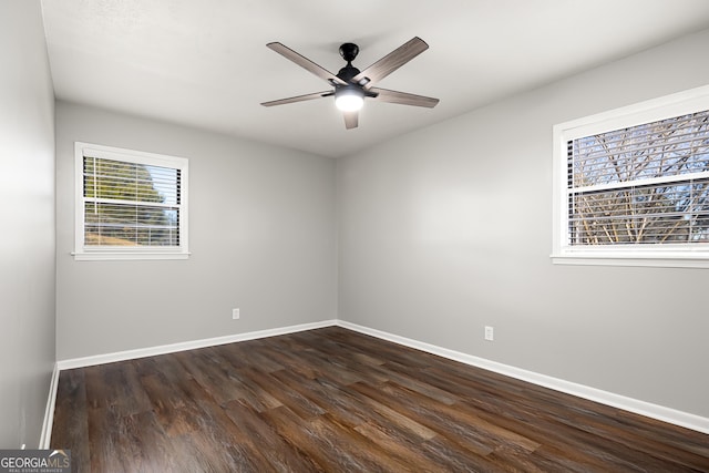 spare room with ceiling fan and dark hardwood / wood-style floors