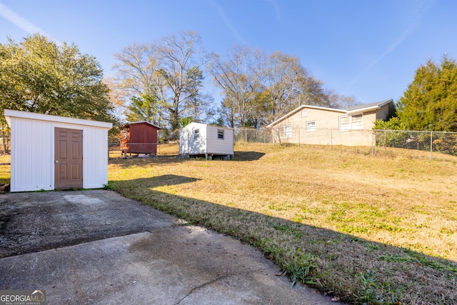 view of yard with a patio area and a storage shed