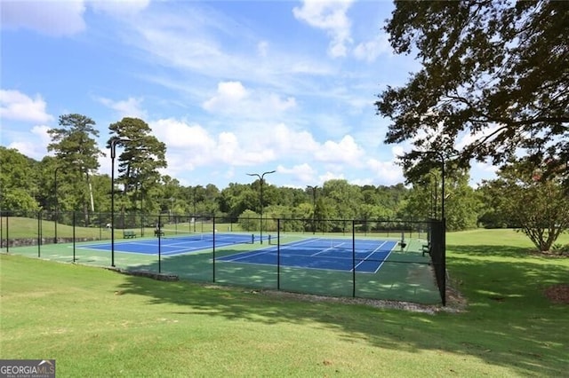 view of sport court with a lawn