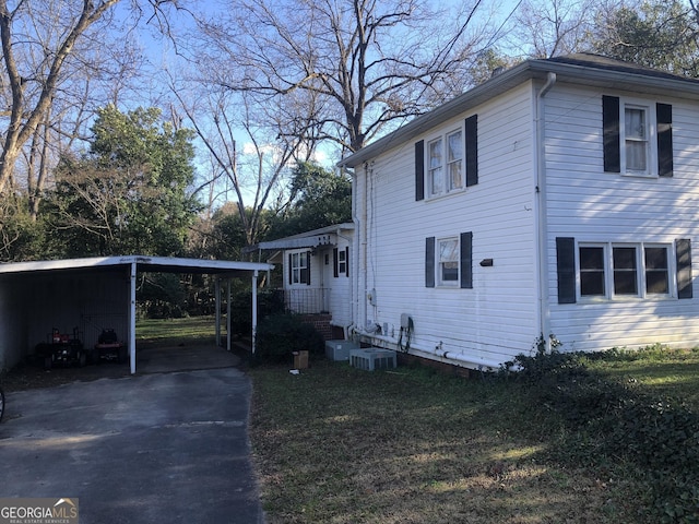 view of home's exterior with a yard and central AC