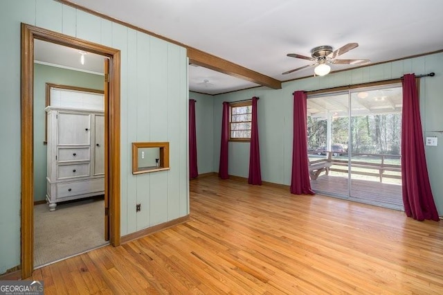 unfurnished room with ceiling fan, beamed ceiling, and light wood-type flooring